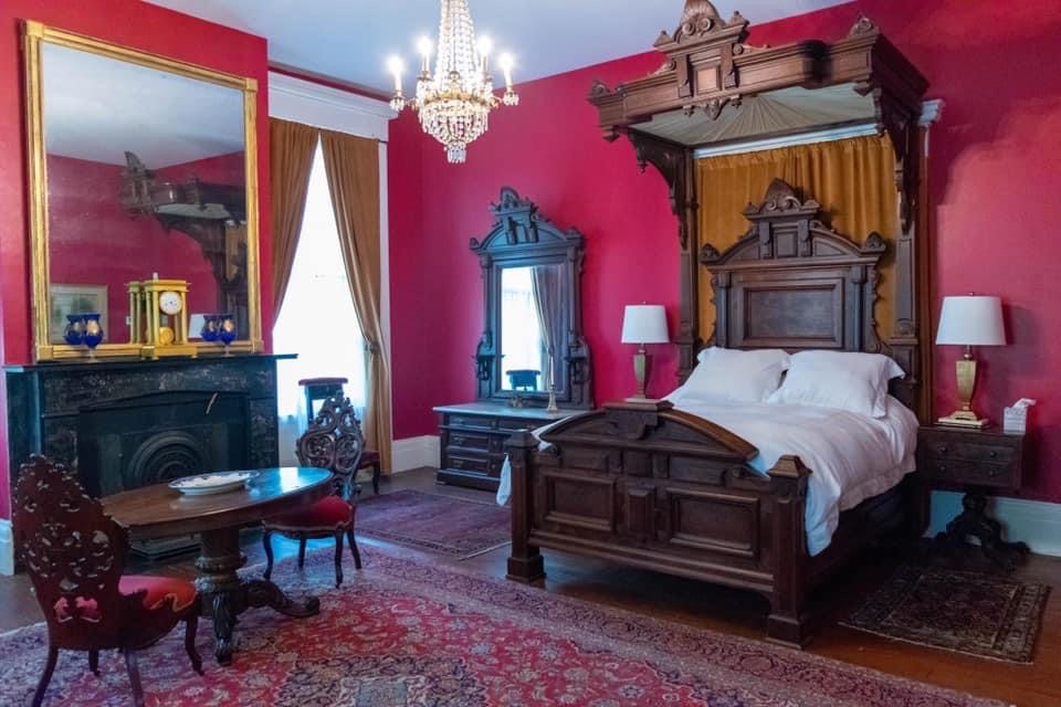 Bishop’s Room: a beautiful red room so named because it was the traditional room the bishop would stay in when paying a visit to his flock. This room has a queen size half tester bed with matching armoire and dresser in the Renaissance Revival style, all made in New Orleans in the 1880s.This room faces the front porch and has two separate ensuite bathrooms: one with a toilet and sink, the other with a sink and shower. The room also has its own Central AC/Heating unit controlled by an in-room wall thermostat.