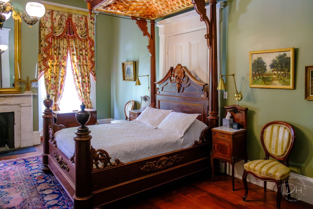 Saint Gabriel’s Room: a beautiful olive green room with opulent curtains and a queen size half tester bed. This room overlooks the canopy of oaks and the camellia garden. It is named for the painting of Saint Gabriel who keeps watch over all who slumber peacefully. This room has an ensuite bathroom with marble vanity, shower, and toilet.